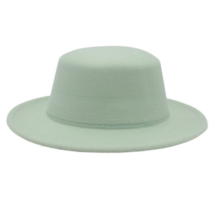 Détail d'un chapeau en feutre de laine vert clair avec bord plat et calotte arrondie