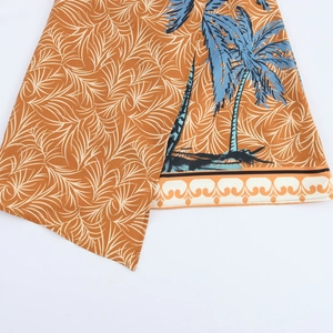 Women's orange coconut tree print strapless dress with irregular hem and tropical pattern