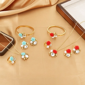 Golden luxury jewelry set with rose pendant, pearls and zircon on champagne silk