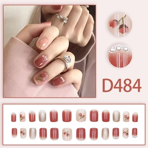 Short square press-on nails with pink gradient, hand-painted tulip, and pearl accents