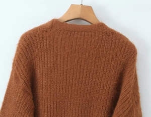 Detail of brown mohair cardigan sweater featuring soft fuzzy texture and knit shoulder
