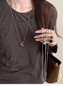 Tiger eye stone planet pendant necklace styled on a model with a casual outfit
