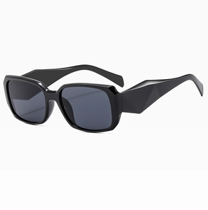 Detail of black rectangular sunglasses with geometric faceted temples and gray lenses
