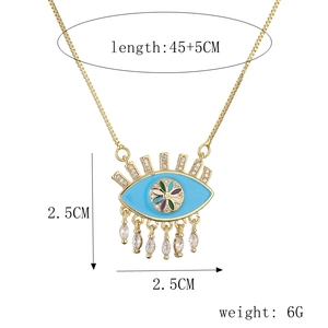 Detail of evil eye pendant with blue enamel, zircon stones, and dimensions 2.5x2.5cm