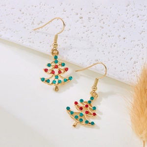 Detailed macro view of golden Christmas tree earrings with red and green rhinestones