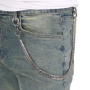 Detail of silver stainless steel Cuban link pants chain with spring clasps on denim jeans