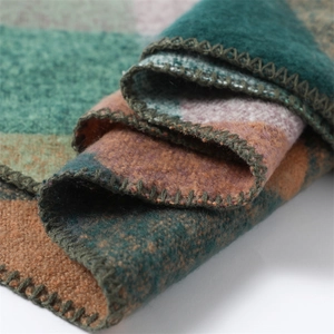 Close-up of multicolored patchwork cashmere feel scarf showing thick knit texture and edges