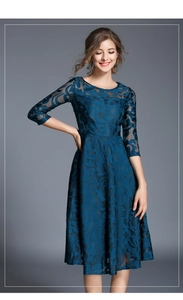 Detail of elegant dark blue lace midi dress featuring sheer sleeves and floral patterns