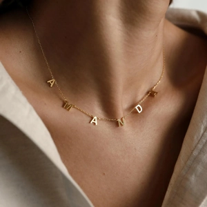 Minimalist gold stainless steel personalized MAMA style letter necklace on a female neck