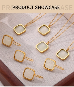 Close-up of 18K gold-plated necklace and earring set with square white resin stones