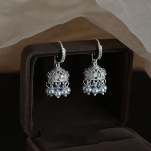 Silver bell Jhumka earrings with hollow metalwork and white pearl tassels for women