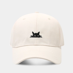 Close-up of minimalist black cat embroidery on a beige cotton baseball cap front