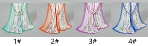 Detailed display of thin chiffon scarves featuring elegant floral botanical prints