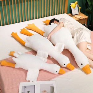 Detailed comparison of three sizes of soft white goose plush pillows in a cozy bedroom