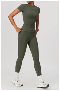 Deep green athletic set featuring high-waisted yoga leggings and slim-fit short sleeve top