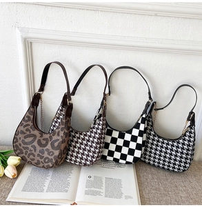 Detail of four retro crescent bags in houndstooth, checkered, and leopard patterns