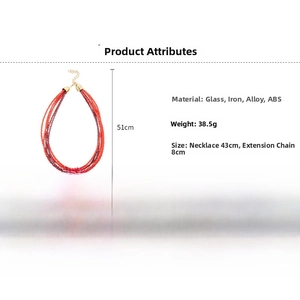 Detail of red multi-strand glass bead necklace with golden alloy extension chain