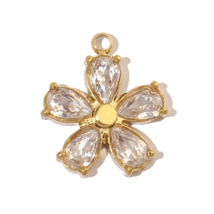 Macro shot of gold floral pendant with five pear-cut zircons and polished metal core