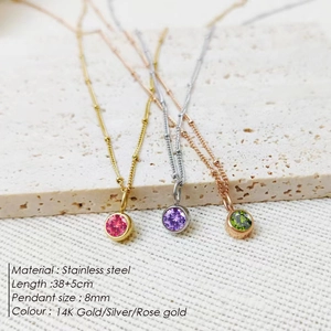 Detail view of stainless steel birthstone necklaces in gold, silver and rose gold