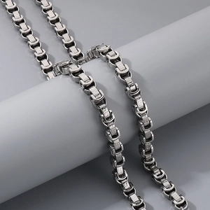 Close-up of a silver stainless steel king chain featuring intricate link patterns