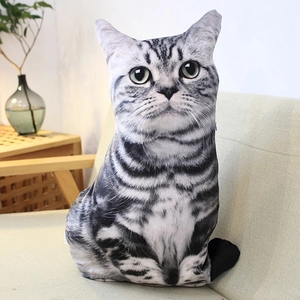Lifelike American Shorthair cat plush pillow placed on a beige fabric sofa at home