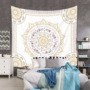 Close-up of mandala tapestry with gold geometric patterns and pink roses on bedroom wall
