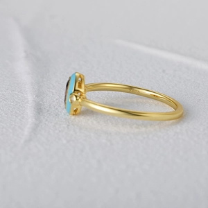 Detail view of gold-plated S925 sterling silver ring with blue stone and S925 hallmark