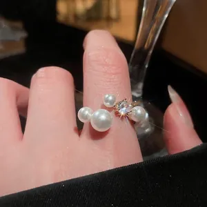 French vintage C-shaped gold ring featuring assorted pearls and a sparkling zircon stone