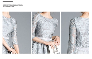 Detail of light blue floral lace embroidery on dress with sheer sleeves and waist belt
