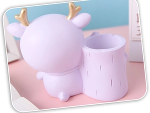 Detail of cute purple deer pen holder with gold antlers for children desk organization
