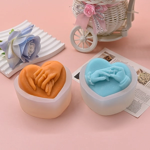 Heart-shaped silicone mold with hand-holding relief for candles, soap, and cake baking