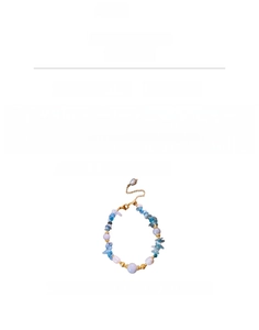 Macro shot of Aquamarine stone beads with copper gold-plated spacers and a pearl charm