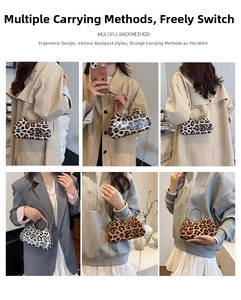 Detail view of leopard print clutch bag with golden ring handle and chain strap options