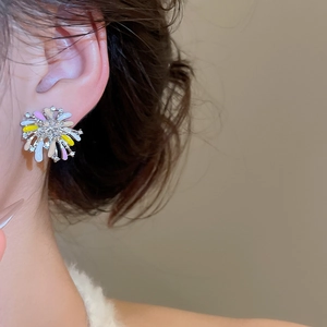 Detailed close-up of a floral stud earring with colorful enamel petals and tiny crystals