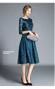 Close-up of intricate floral lace texture and embroidery on this dark blue dress