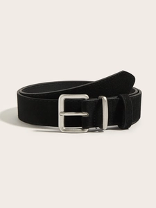 Close-up of black suede texture on vintage wide waist belt with silver metal buckle