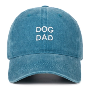 Detail shot of white 'DOG DAD' embroidery on a vintage blue washed cotton baseball cap.