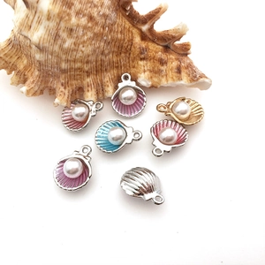 Detailed view of colorful shell pendants with pearls for DIY jewelry making accessories