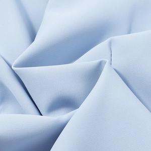 Close-up detail of light blue fabric texture showing premium weave and soft drape