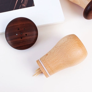 Handcrafted walnut and light wood mushroom toothpick holder with a minimalist design