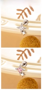Detail showing starburst titanium steel earrings with clear and pink square crystals