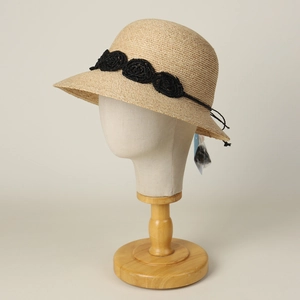 Elegant beige raffia bucket hat with black crochet flowers and string tie for summer beach