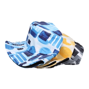 Close-up of assorted outdoor bucket hats with blue, yellow, and grey geometric patterns