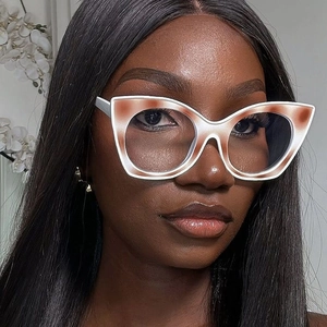 Close-up of cat-eye frames in cream white and brown gradient on a female model