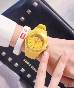 Close-up of yellow waterproof sports watch with silicone strap on a wrist