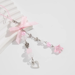 Detail of pink ribbon bow phone charm with strawberry beads and metal heart pendants