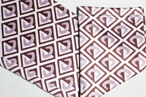 Macro shot of geometric burgundy pattern on twill fabric of long-sleeve jumpsuit