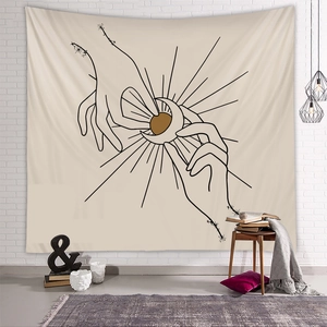 Minimalist hand holding sun and moon tapestry on white brick wall with home decor