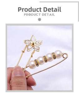 Detail of vintage gold brooch with crystal flower and pearls for waist tightening