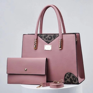 Close-up of pink leopard print tote bag and matching wallet with gold metal logo